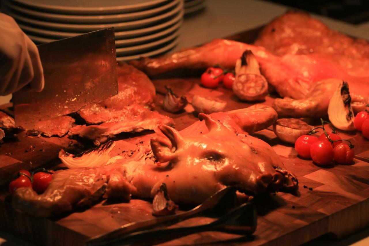 Chatrium Grand Bangkok Exterior photo A carving station with roast chicken